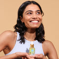 happy girl holding Acai Skin Balancing Face Oil